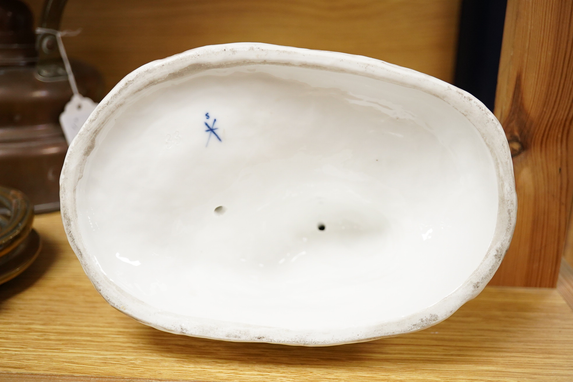 A German porcelain group of two figures with a bird cage and dog, 24cm high (Restored)